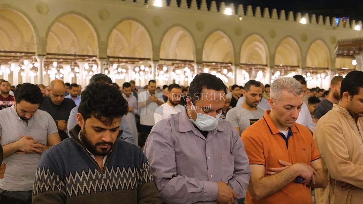 Worshipers praying in a mosque, performing the obligatory prayer in the mosque, worship and draw close to God