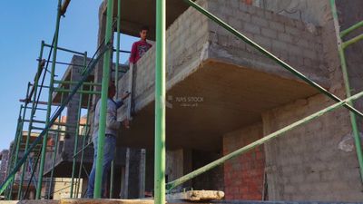 Worker paints buildings with cement
