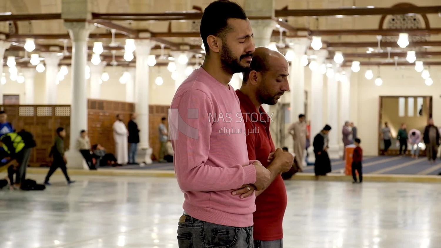 Worshipers praying in a mosque, performing the obligatory prayer in the mosque, worship and draw close to God