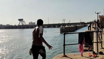 Young man enjoys jumping and swimming in the Nile River