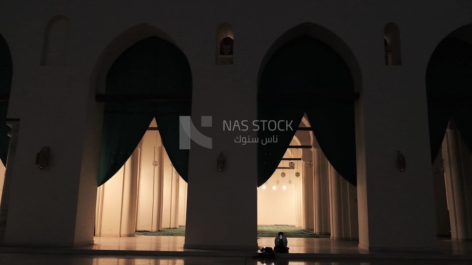 Woman sitting on the floor holding her mobile in Al-Hakim Mosque, by God&#39;s command, tourism in Egypt, tourists, famous mosques in Egypt