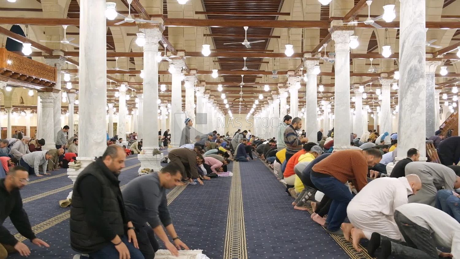Worshipers praying in a mosque, performing the obligatory prayer in the mosque, worship and draw close to God