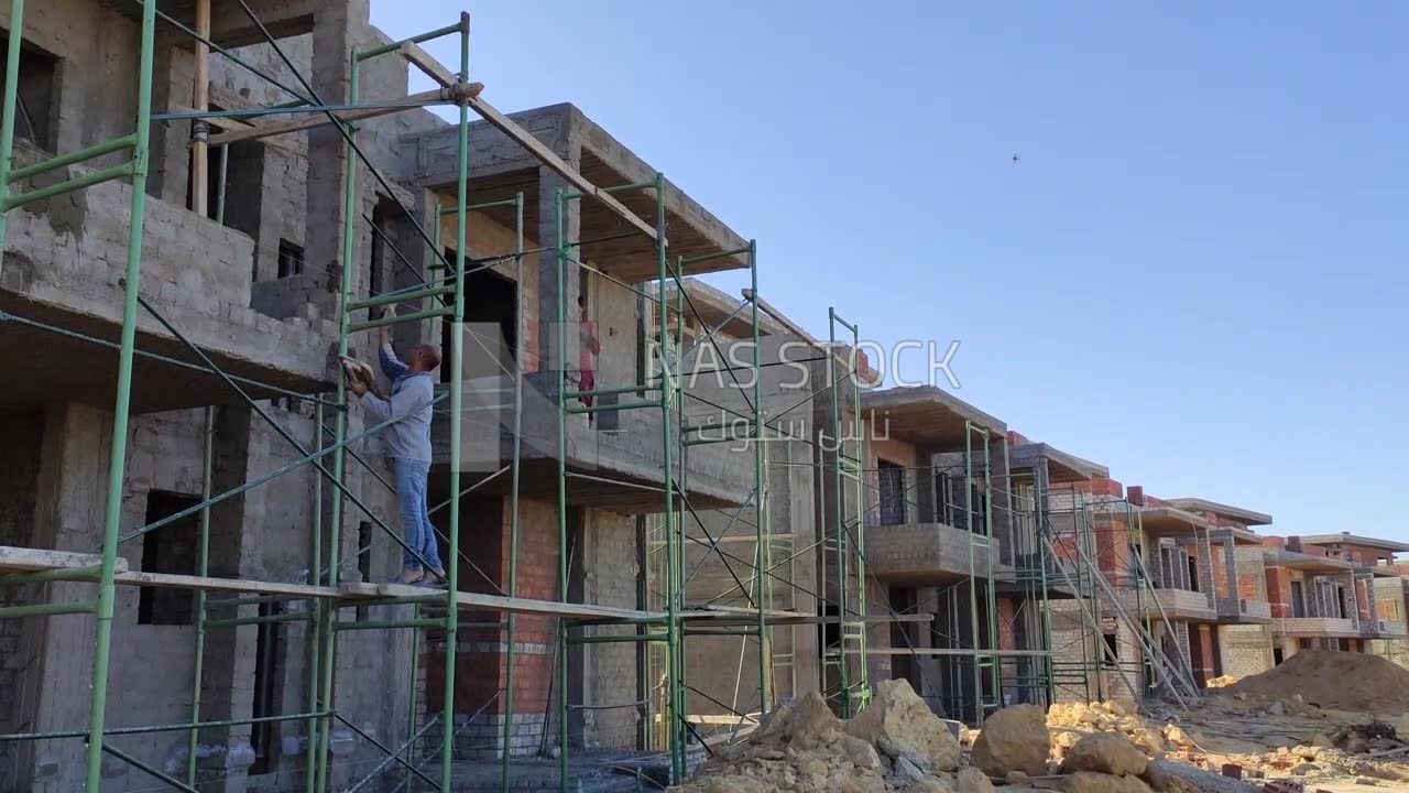 Worker who finishes the facade of the buildings