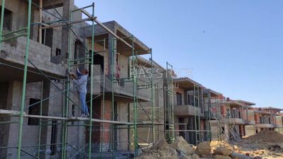 Worker who finishes the facade of the buildings