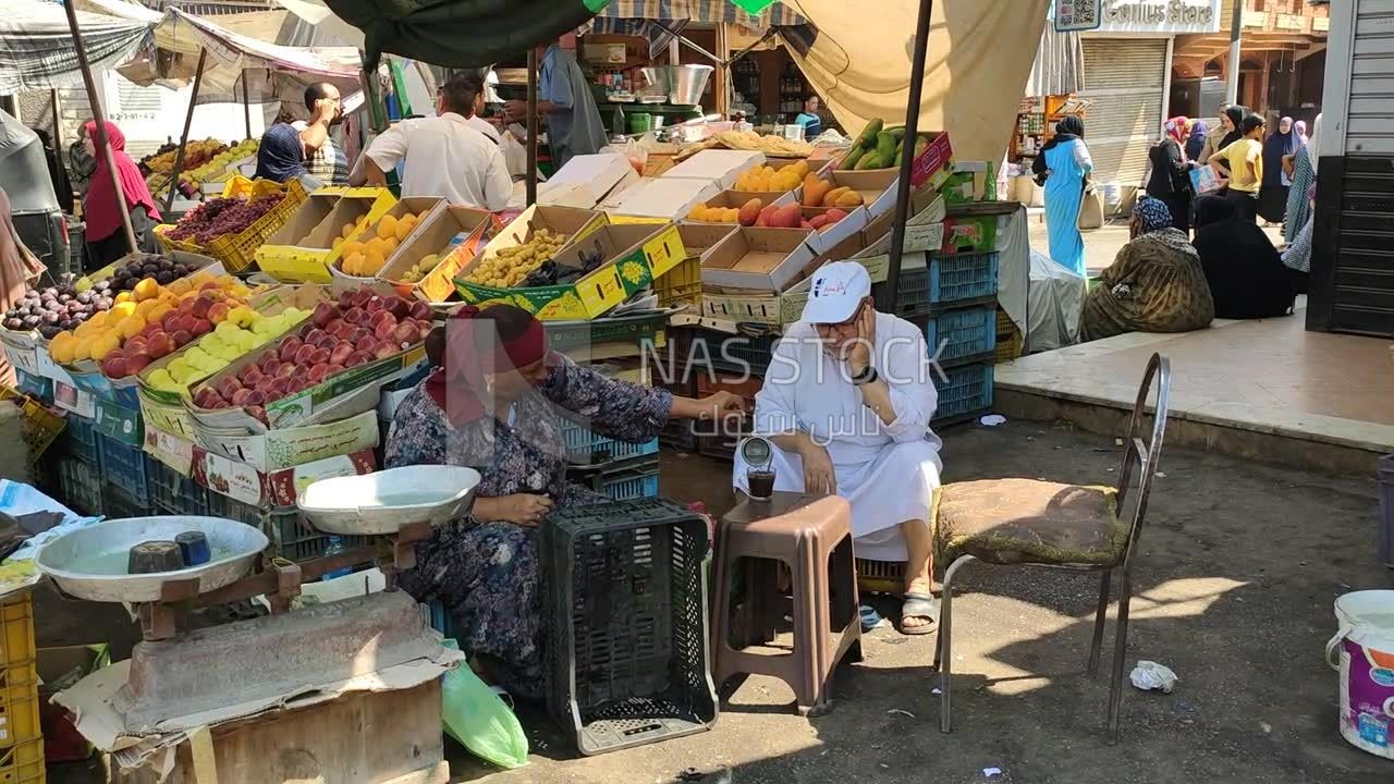 Couple selling fruit resting to drink tea together