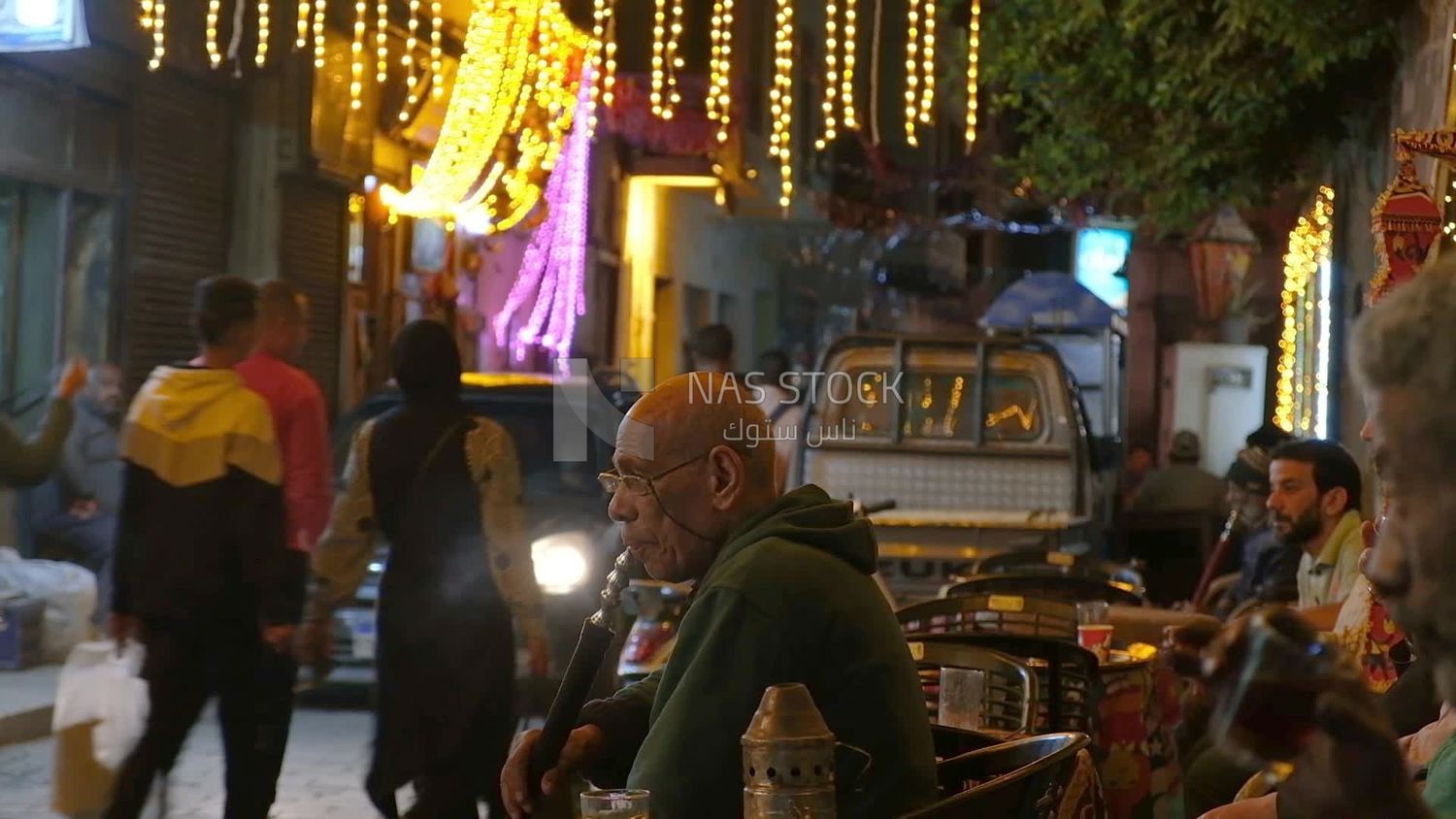Man drinking hookah in a street coffee