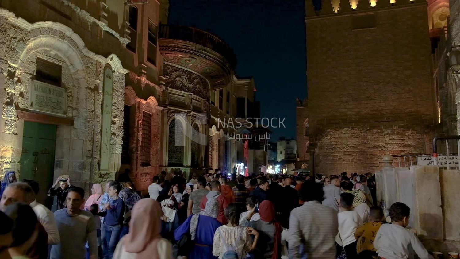 People on Al Moez Street at night, decoration lights