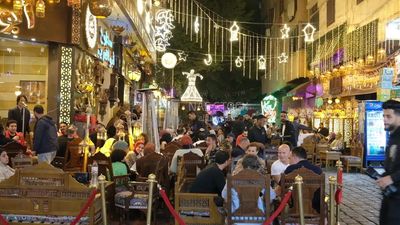 People sitting in a street coffee shop, Ramadan