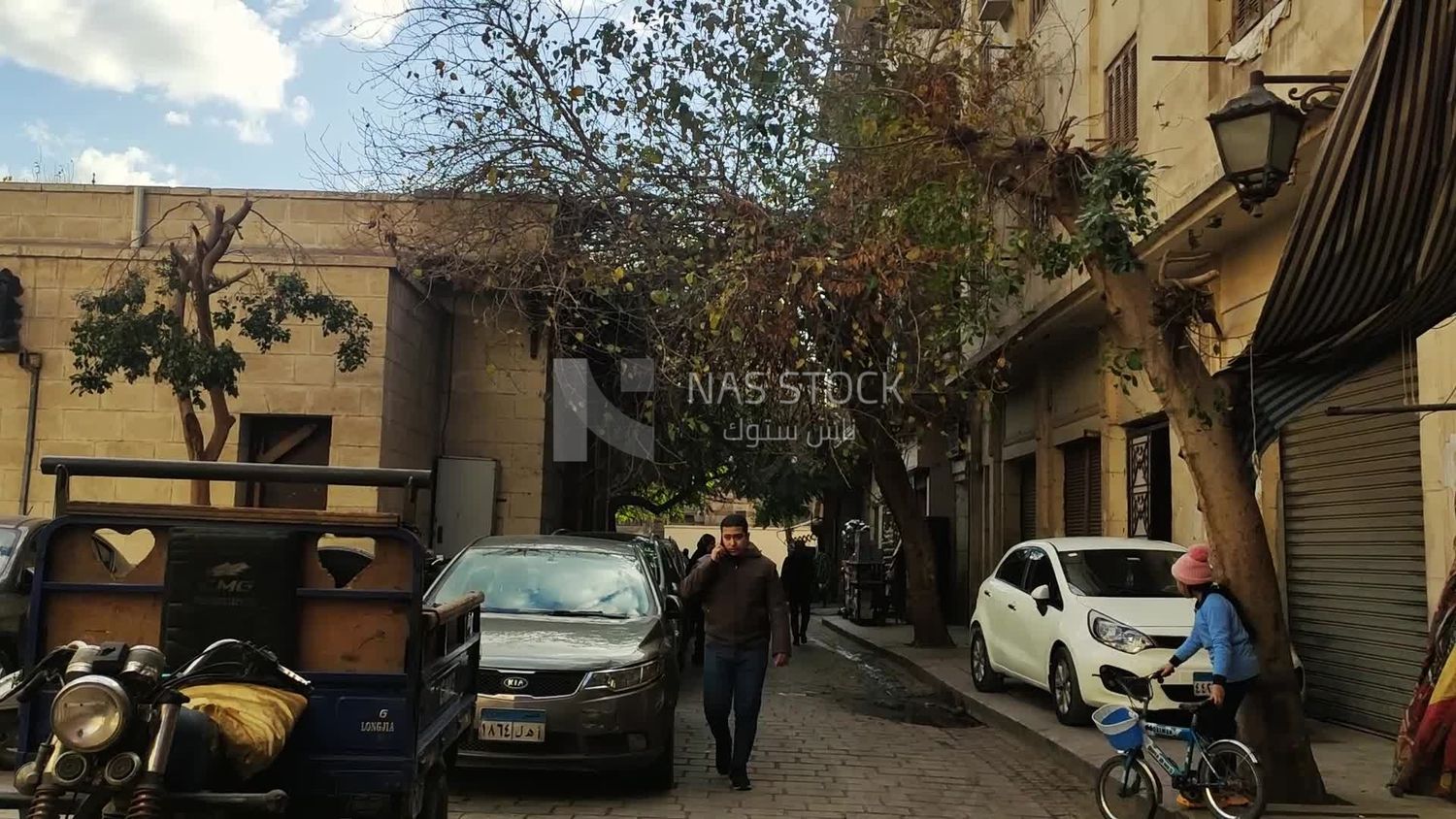 Person talking on the phone and walking in one of the streets of Old Cairo
