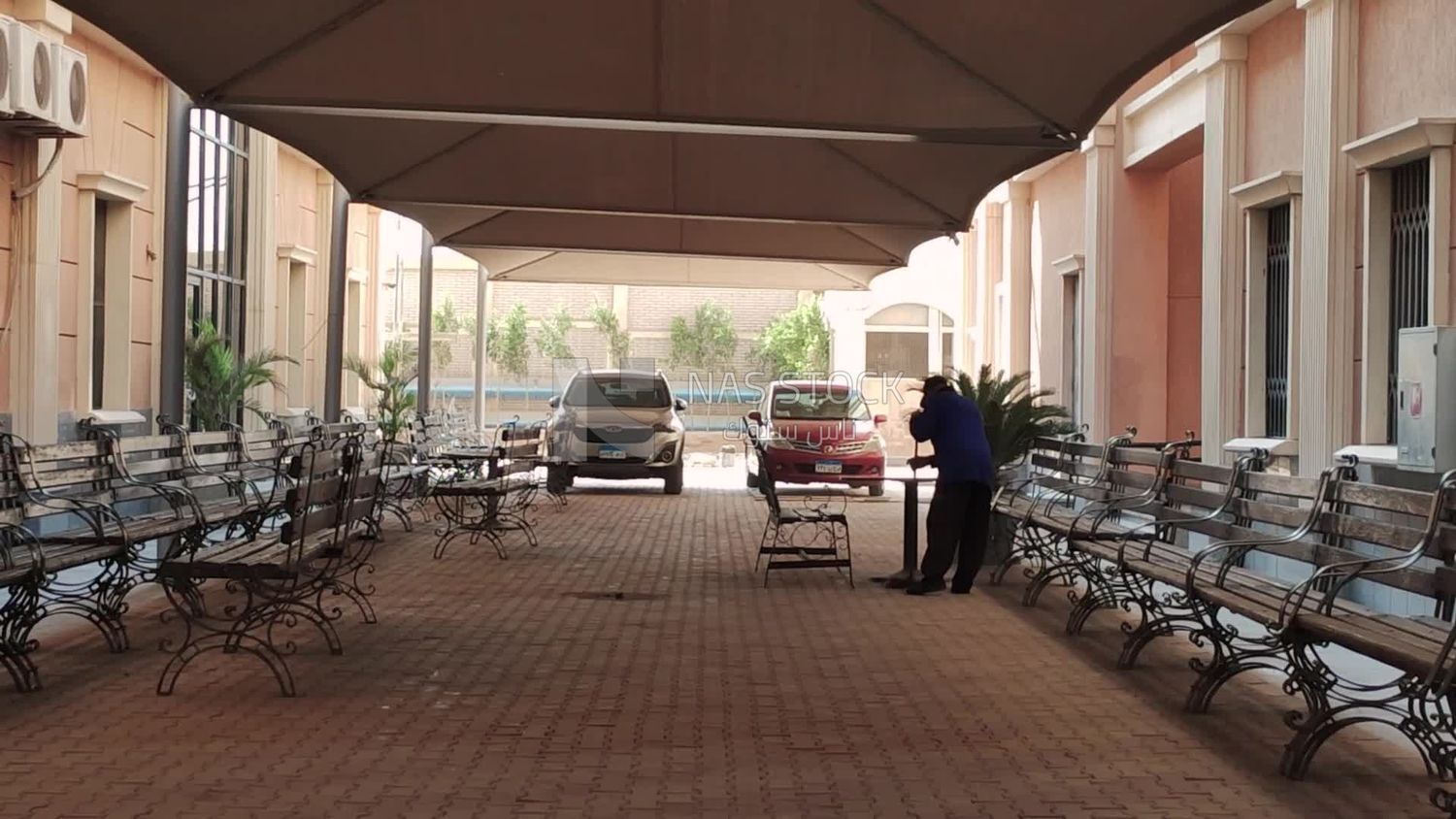 Waiting benches in the shade inside the Canadian University garage