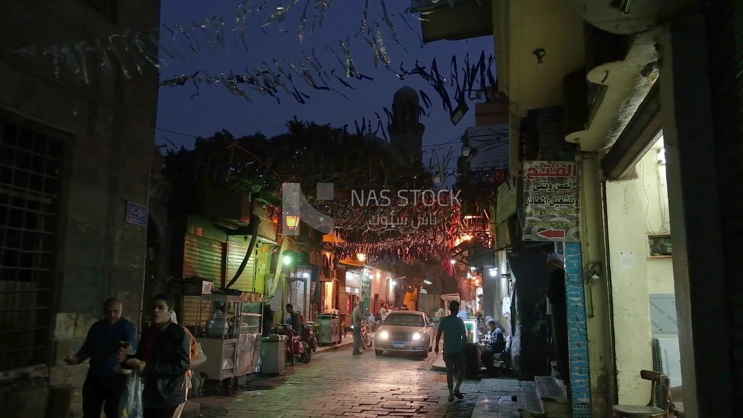 People on Al Moez Street at night, decoration lights