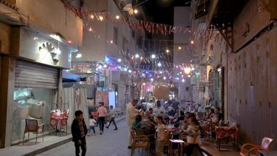 People sitting in a street coffee shop, Ramadan