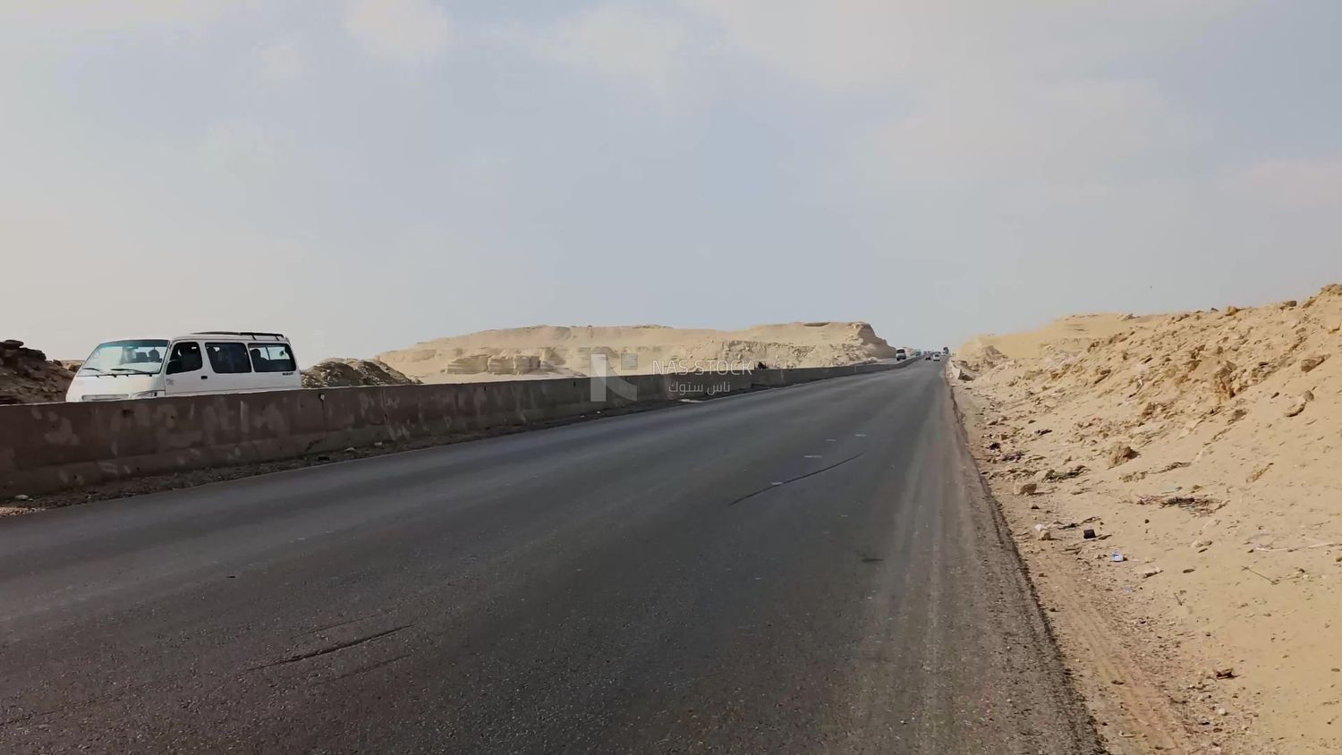 Video showing a camera that depicts the golden yellow sand that is found on both sides of the desert road