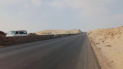 Video showing a camera that depicts the golden yellow sand that is found on both sides of the desert road