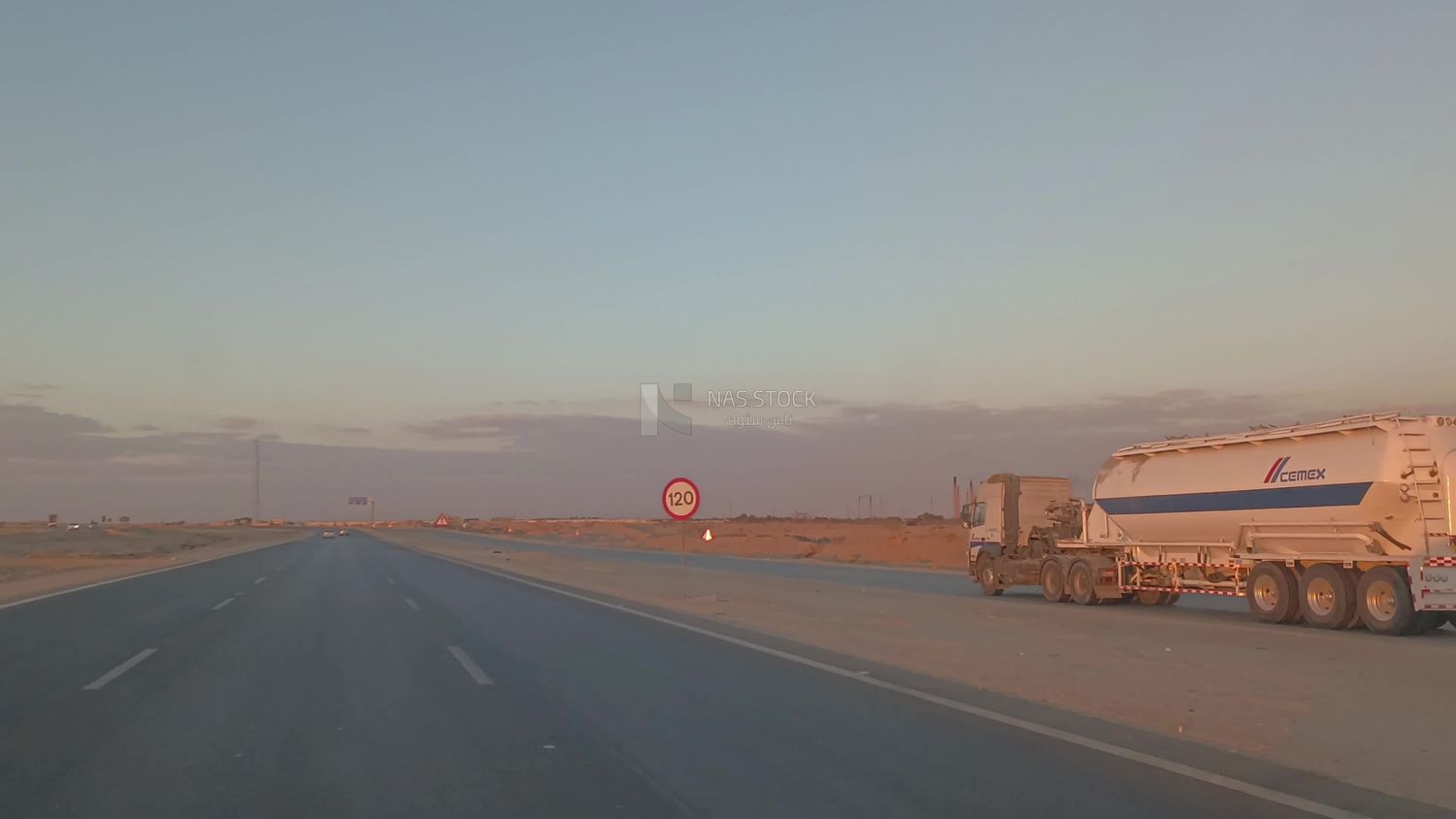 Video from inside a car traveling on the desert road with a stunning sunset view