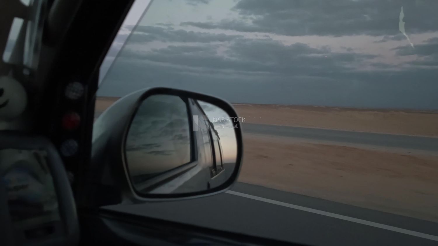 Video of a photographer riding a fast car on a desert road