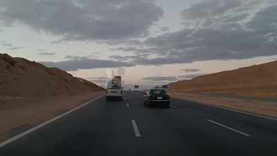 Video showing traveling on the desert road with a stunning view of the sunset