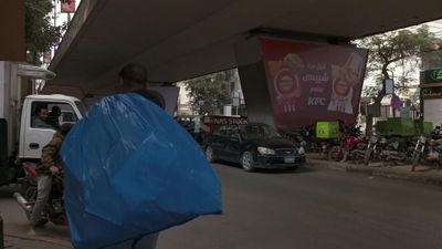 Video showing a street under a bridge in Zamalek, where cars and pedestrians drive