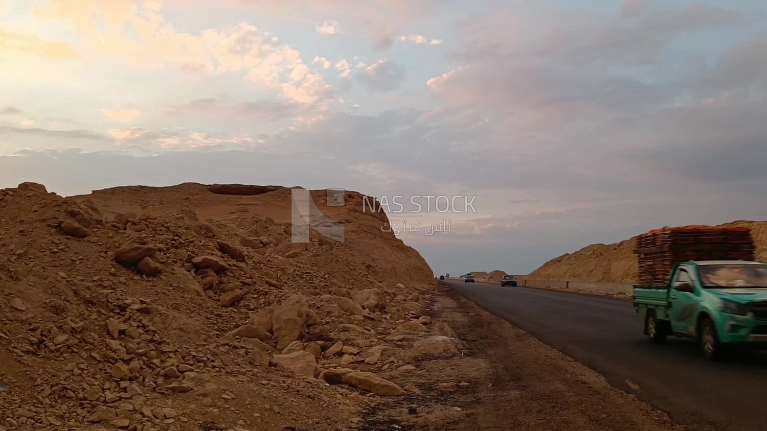 Video showing the golden yellow sands and desert mountains on both sides of the desert road