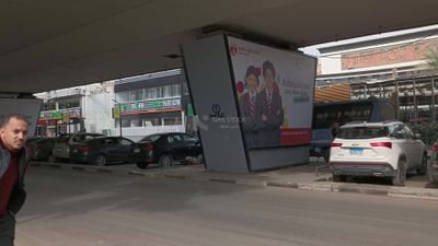 Video showing a group of cars standing and others driving under a bridge in Zamalek