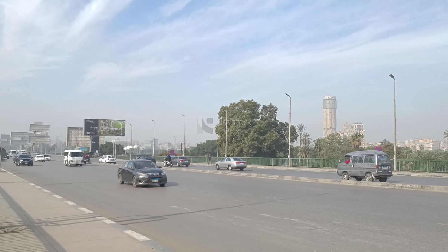 Video showing one of the wide streets of Zamalek in Cairo, where cars are moving quickly