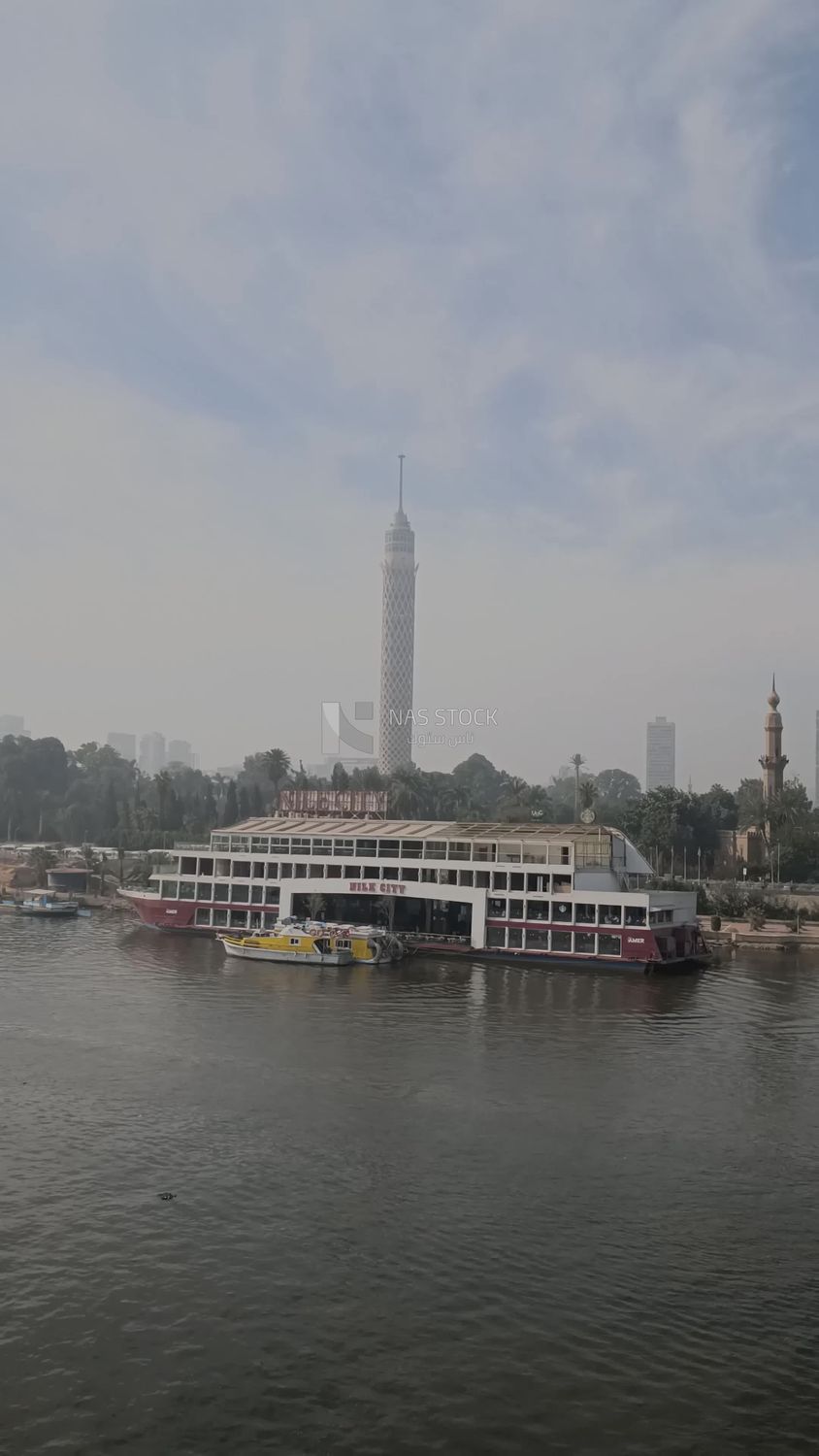 Video showing the Nile City boat mooring in the Nile River, with the Cairo Tower behind it