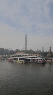 Video showing the Nile City boat mooring in the Nile River, with the Cairo Tower behind it