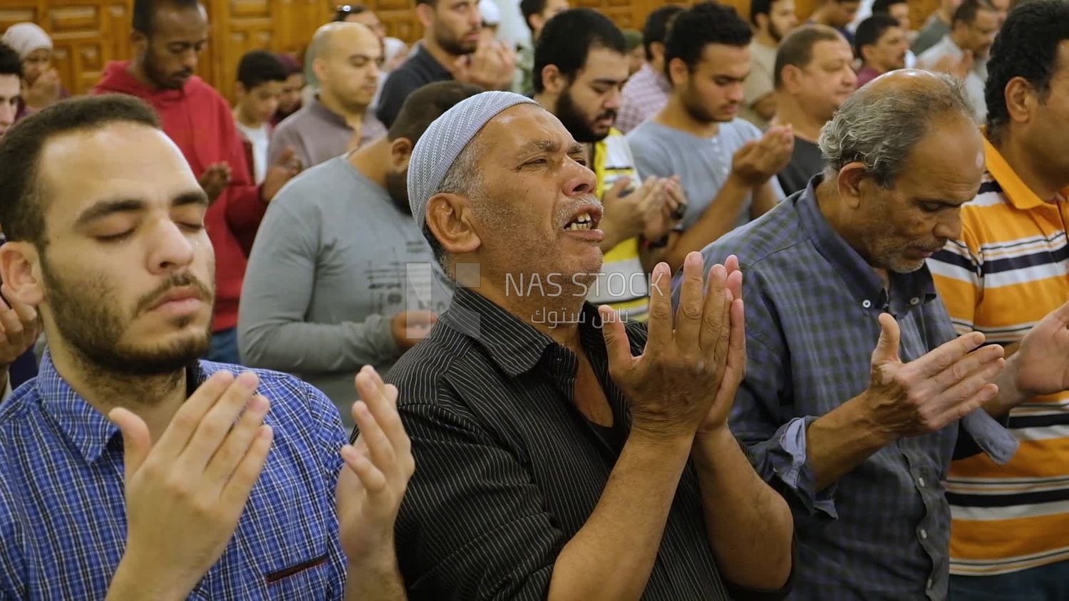 Man in the mosque, praying and crying to God, praying on the prayer rug, performing the obligatory prayer in the mosque, worship and draw close to God