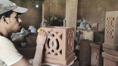Man in the pottery workshop making a pottery box