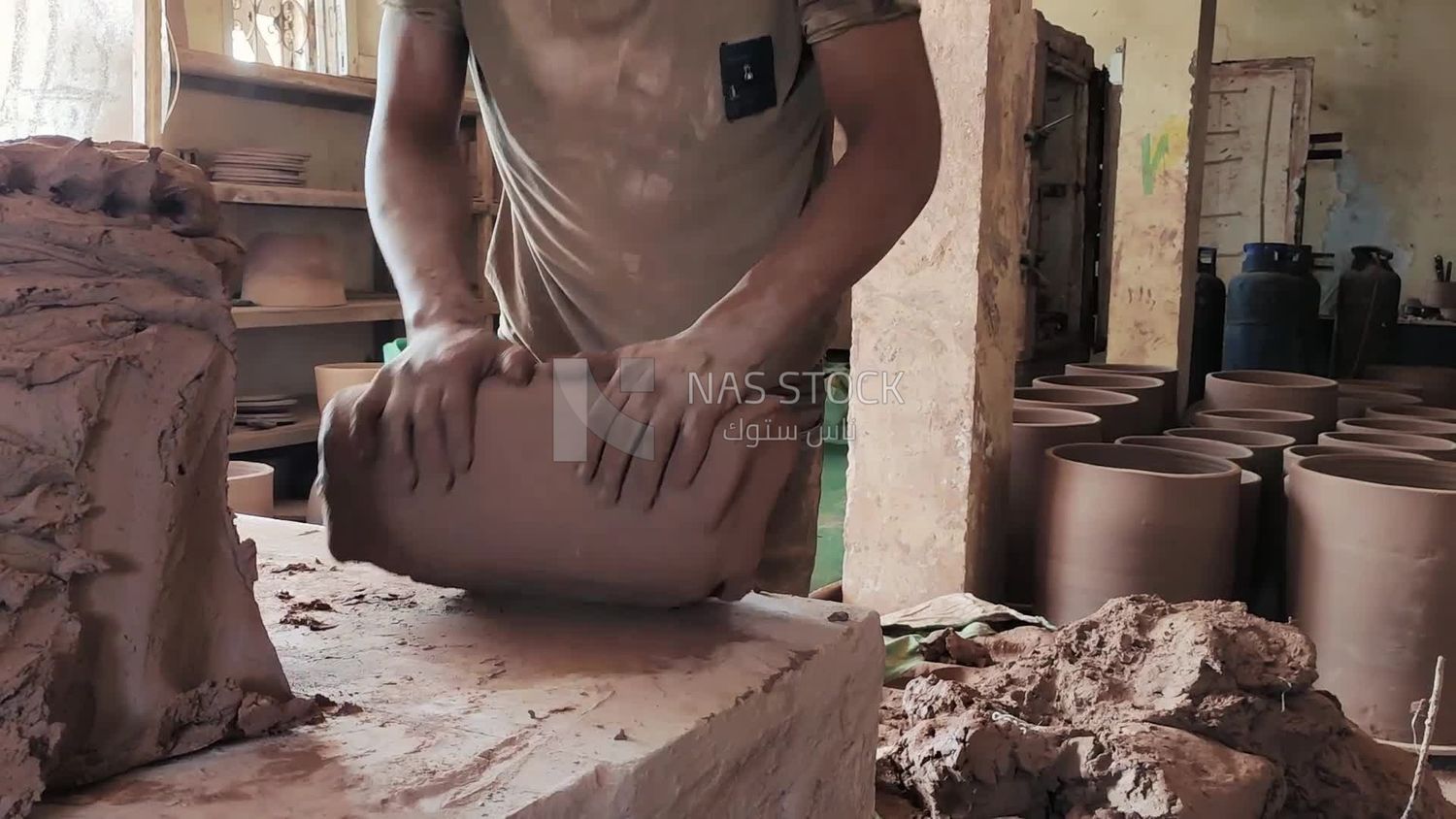 Man prepares pottery dough to be able to shape it