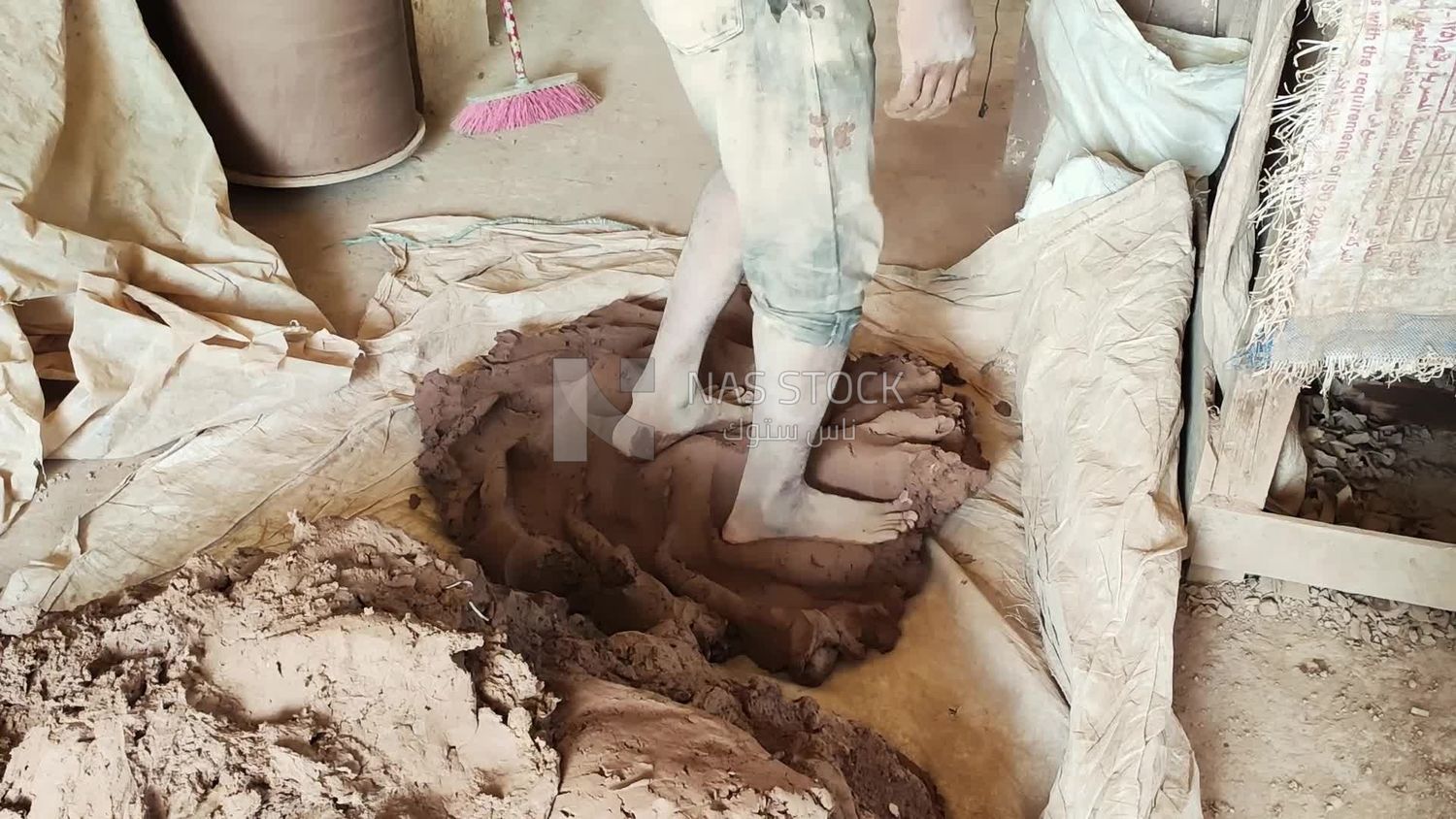 Man prepares pottery dough to be able to shape it