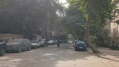 Video shows a delivery worker on a motorcycle walking in a quiet street in the Zamalek neighborhood in Cairo