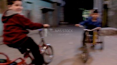 Boy riding a bicycle in the street, street, Ramadan Kareem