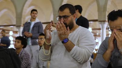 Man in the mosque, praying and crying to God, praying on the prayer rug, performing the obligatory prayer in the mosque, worship and draw close to God