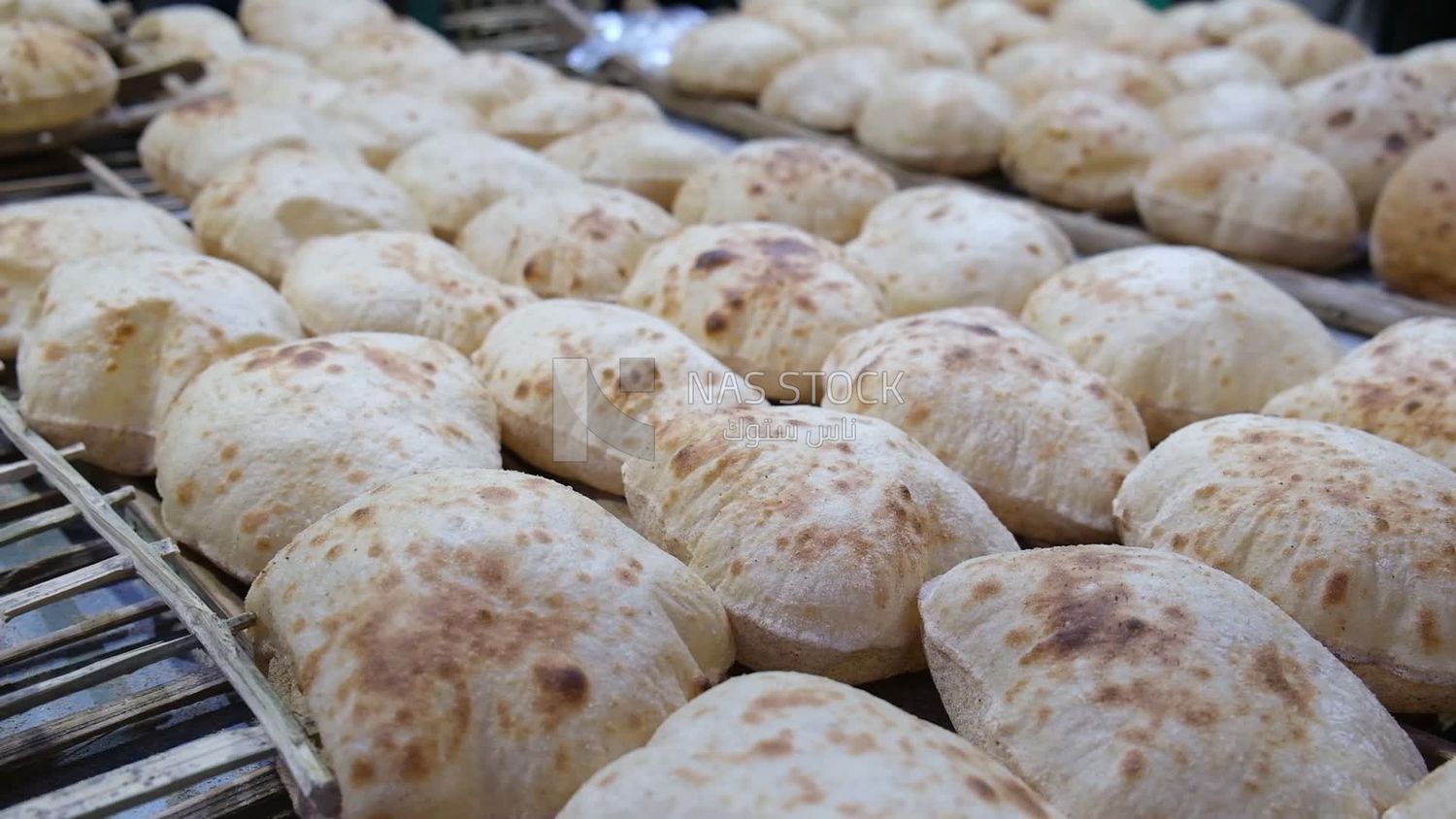 Man selling in a bakery, street, decoration lights