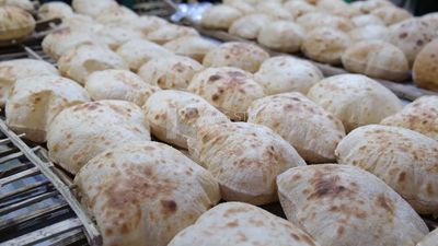 Man selling in a bakery, street, decoration lights