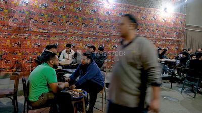 People sitting in a street coffee shop, Ramadan