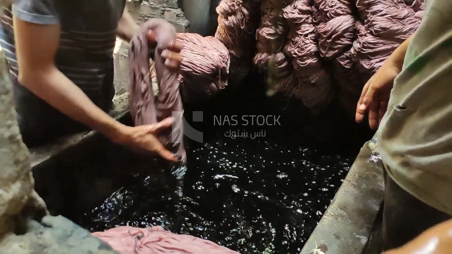 Two men work in a dyeing workshop