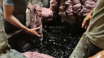 Two men work in a dyeing workshop
