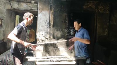 Two men work in a dyeing workshop
