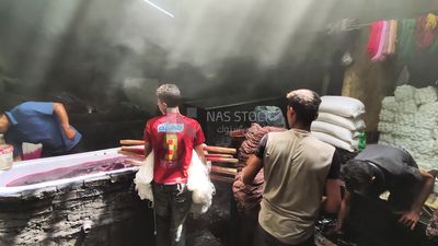 Group of people working in a workshop for dyeing yarns and fabrics