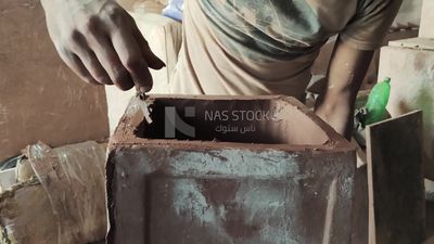 Man in the pottery workshop making a pottery box