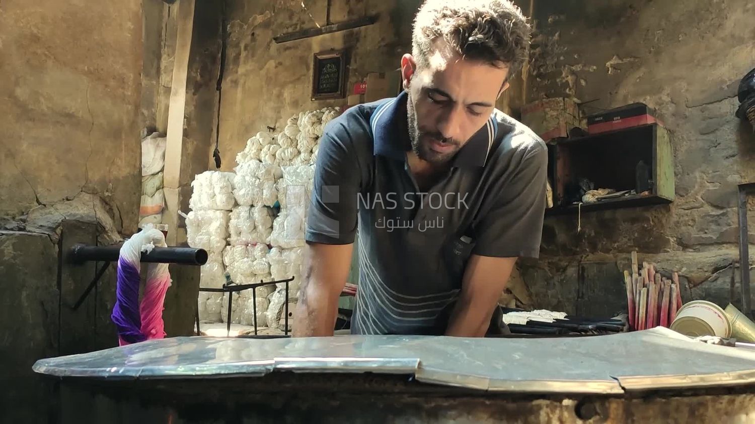 Man works in a yarn dyeing workshop