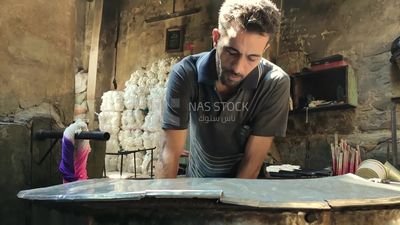 Man works in a yarn dyeing workshop