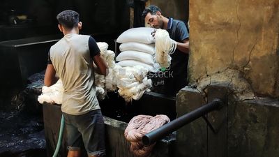 Man works in a yarn dyeing workshop