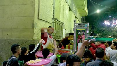 Man standing in a street restaurant, traditional breakfast, street food