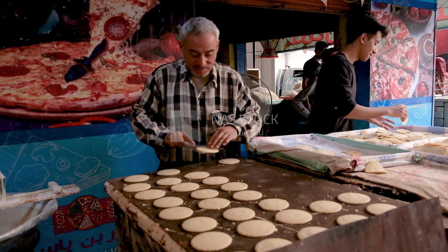 Man standing in qatayef store, Ramadan sweets, Ramadan kareem