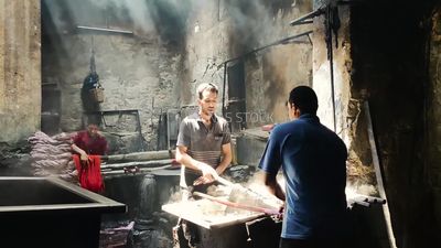 Two men work in a dyeing shop