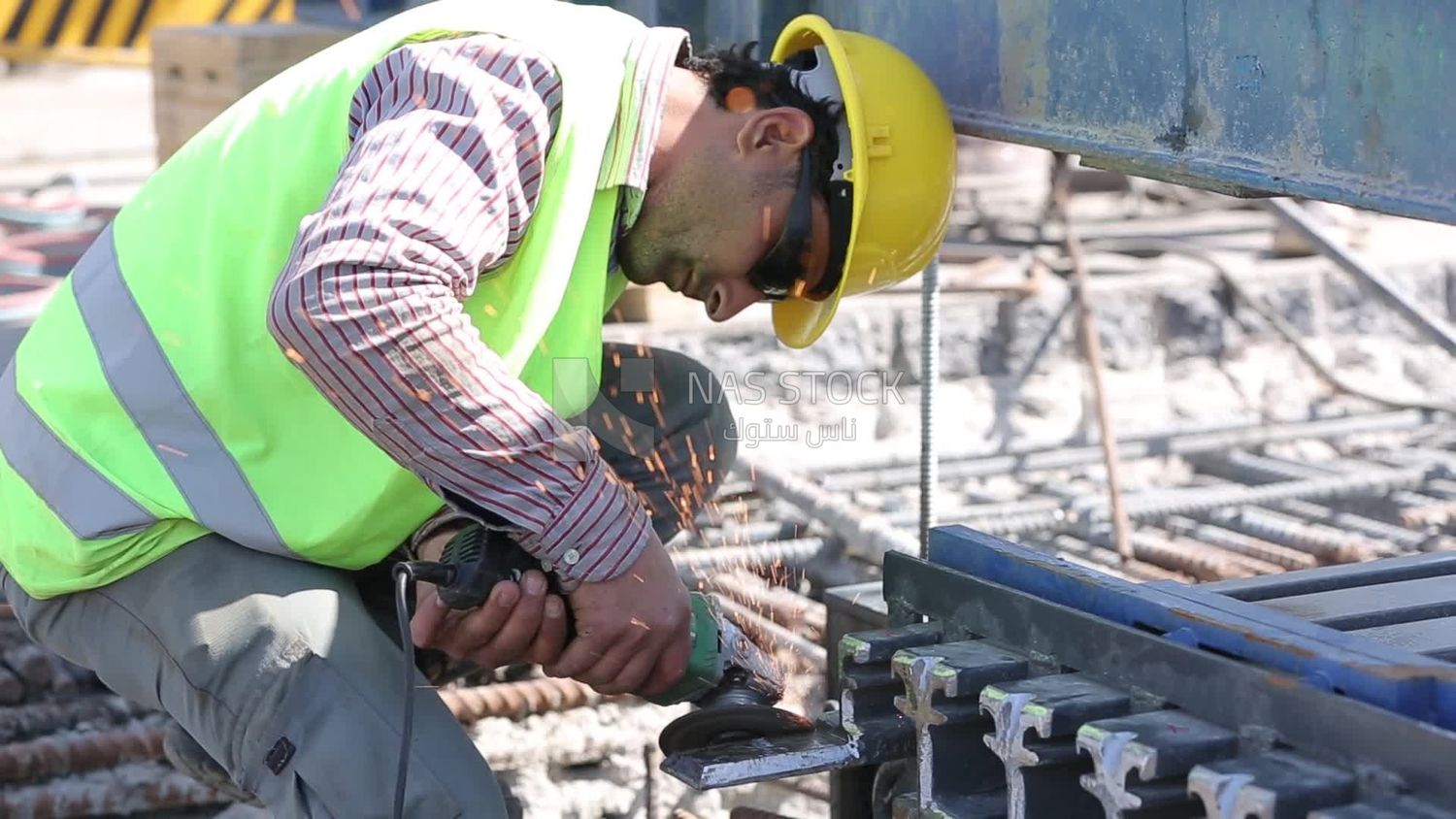 Worker cutting rebar by grinding machine,  engineering tools and equipment