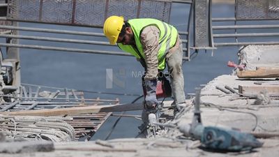 Worker using a drill to make a hole in the ground